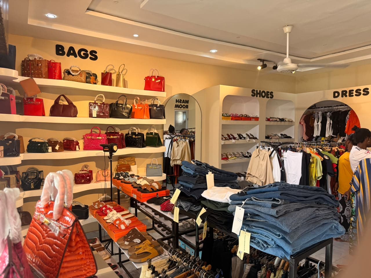 Bags, shoes and dresses on the shelves inside Jana's Luxuries